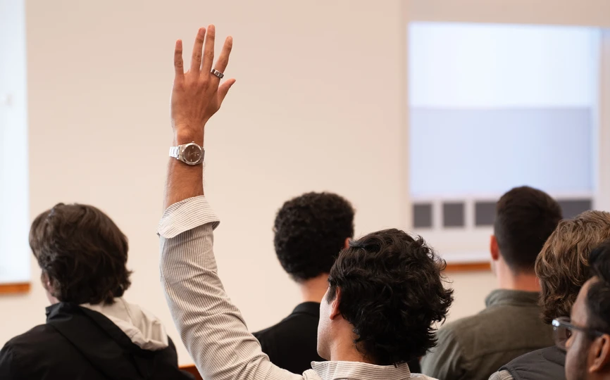 A Stern alum raises their hand during an alumni event