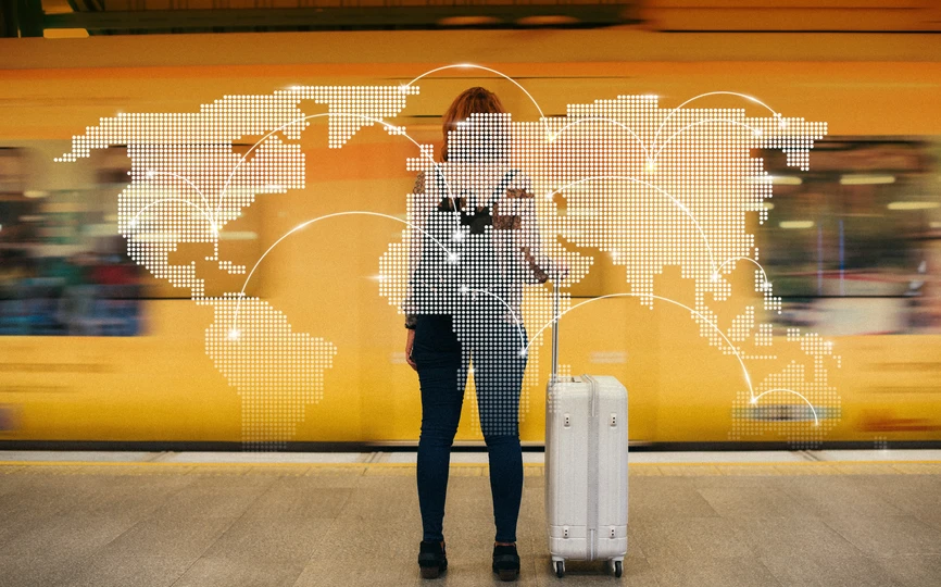 A transparent map of the world over a woman with a suitcase