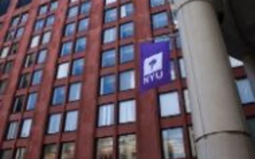 NYU Stern Tisch building with NYU flag