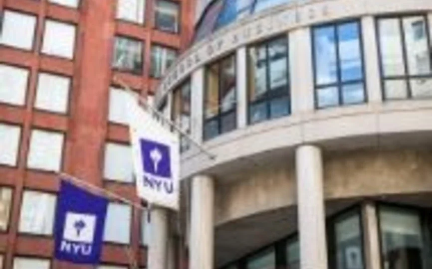 Front facade of Stern building with NYU flag