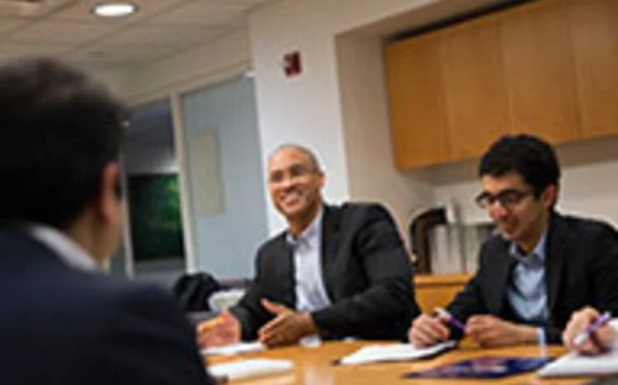 Dean Emeritus and Professor Peter Henry meets with students. 