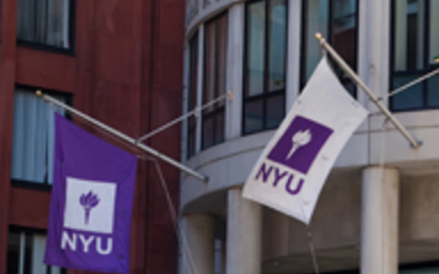NYU flags outside of the Henry Kaufman Management Center