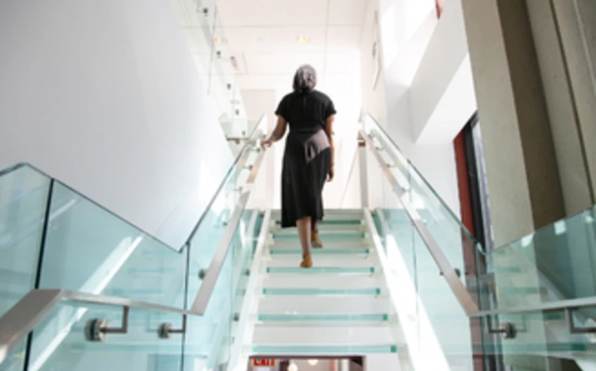 Woman walking up set of stairs