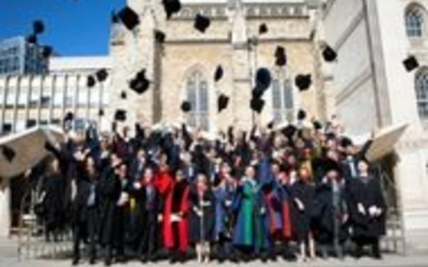 TRIUM graduates throw their caps in the air