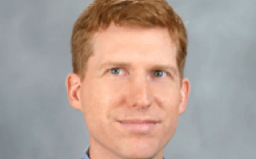 headshot of robert seamans in front of a grey background