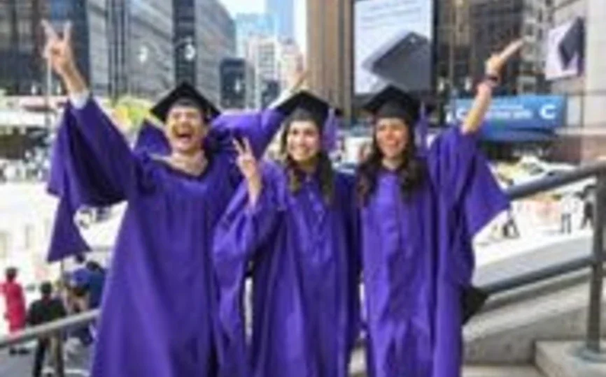 Three students celebrate outside of MSG before their May 10 graduation ceremony.