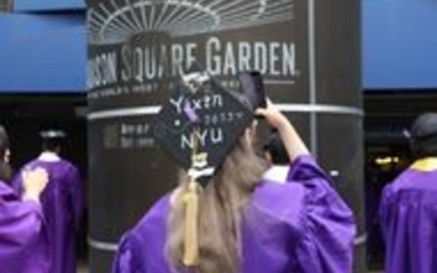 A student takes a selfie outside of MSG on May 20 to celebrate graduating.