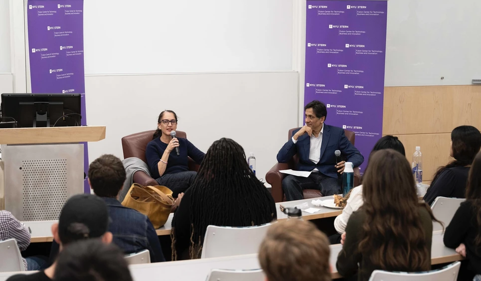 Liza Landsman addresses students while sitting with Professor Sundararajan