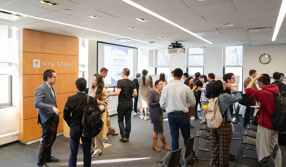 many conference attendees stand and visit with each other