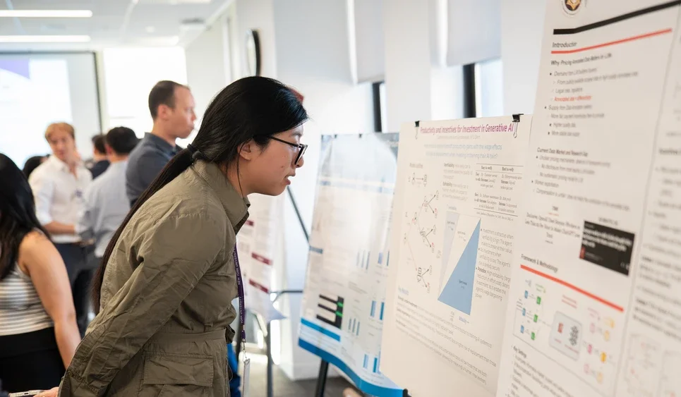 workshop attendee reads several posters