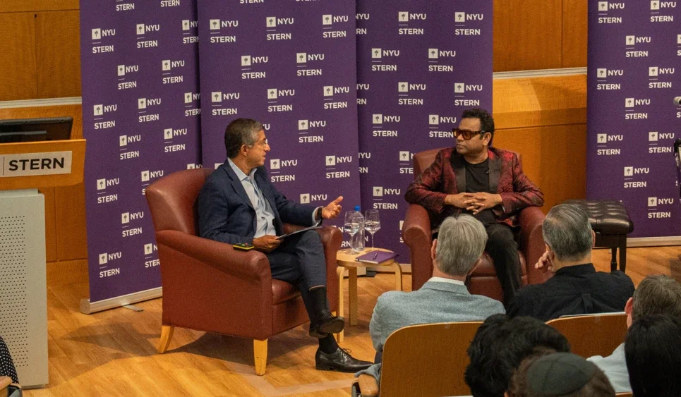 Dean Bharat and A R Rahman sitting in conversation in front of an audience