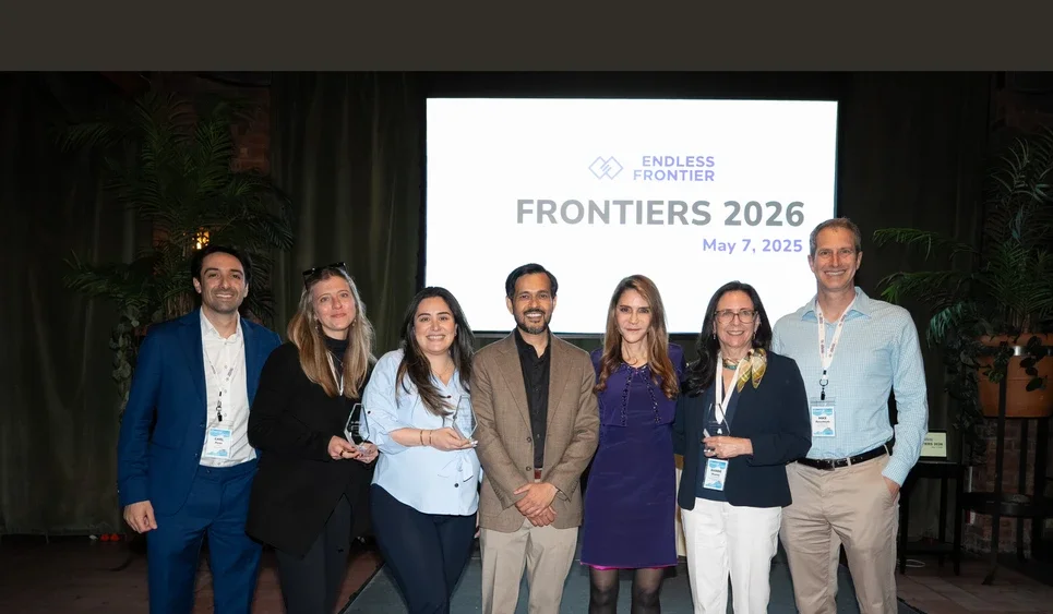 A group stands in front of a sign reading "Frontiers 2026" with the Endless Frontier Labs logo