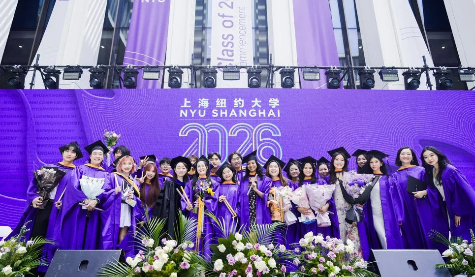 A group of students post for a photo as NYU Shanghai’s Business Ceremony recognized Class of 2026 graduates from the four joint NYU Shanghai and NYU Stern MS programs.