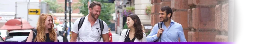 banner of four people walking and talking down the street