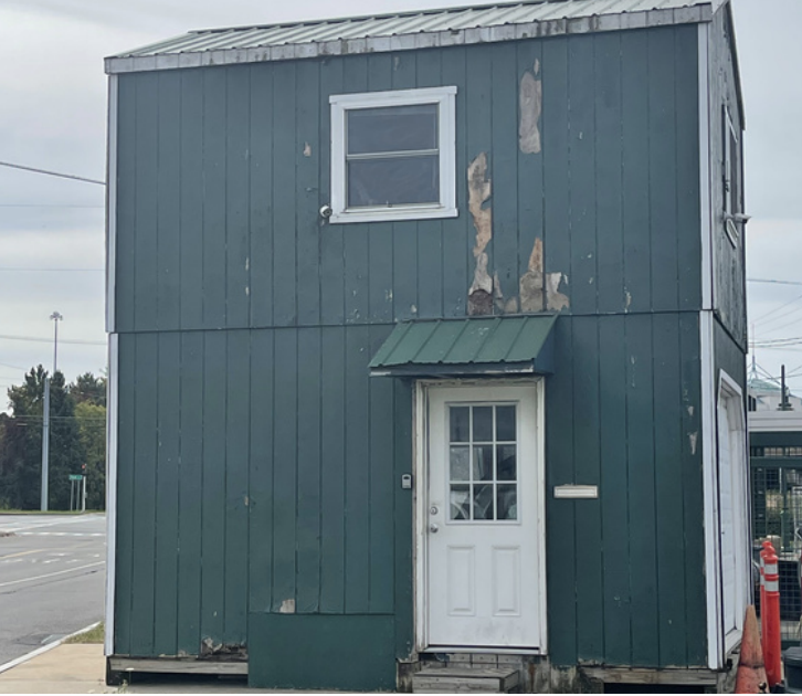 Green building with paint chipping