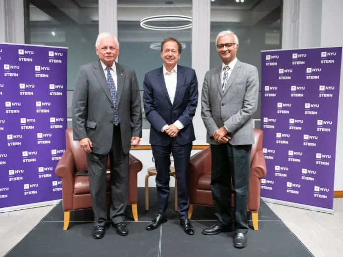 Dean Raghu Sundaram at a fireside chat with John Paulson (BS ’78)