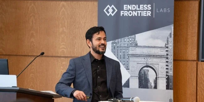 Deepak Hegde stands at a podium