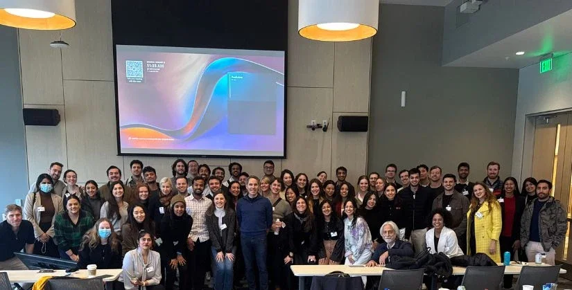 Jeff Teper poses with a group of students in front of a projector