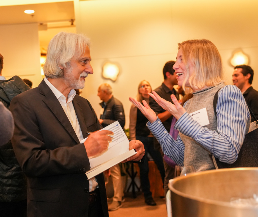 Professor Vasant Dhar signing books and mingling with alumni