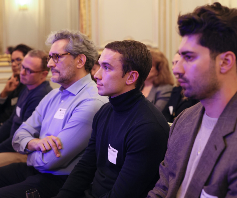 Alumni attending a fireside chat with Professor Sam Chandan in Paris