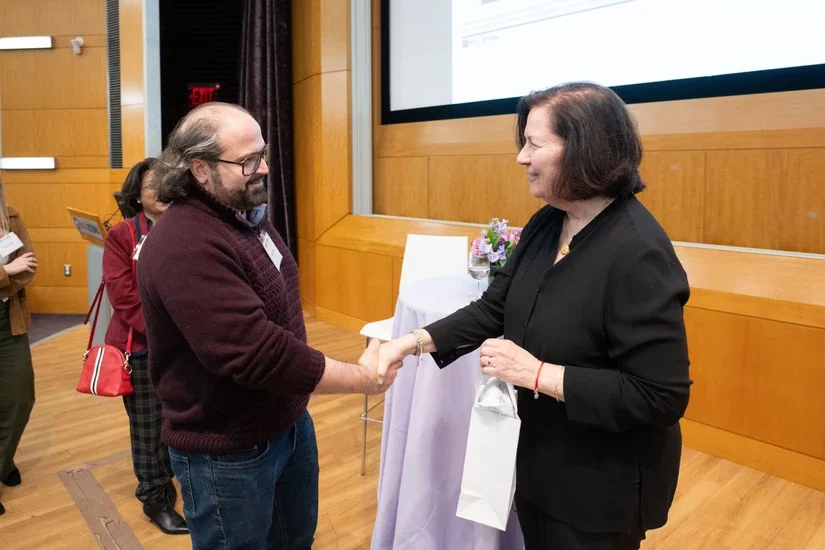 Alumni mingling with Professor Anat Lechner