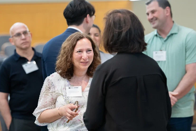 Alumni mingling with Professor Anat Lechner