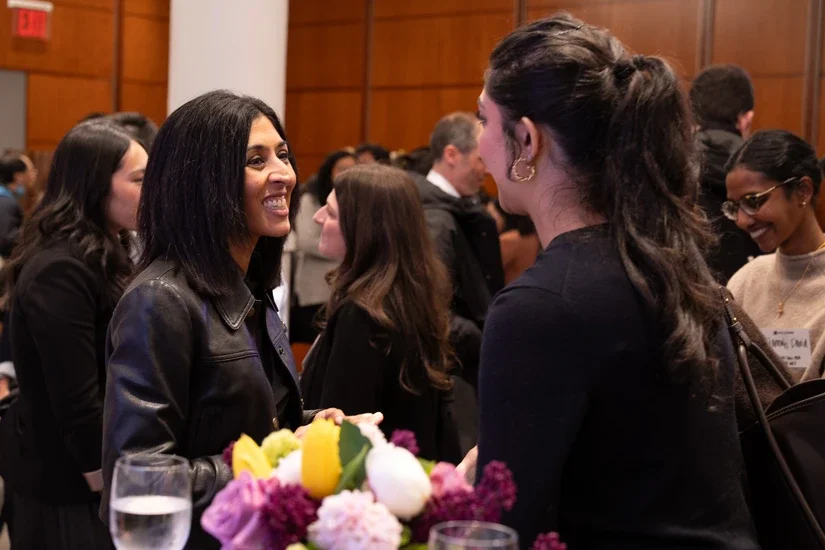 Panelists mingling with alumni