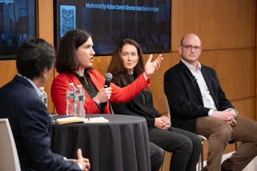 Ali Heron speaks next to fellow panelists