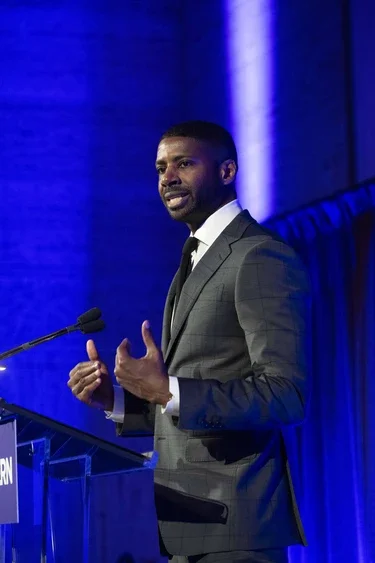 Tony Watkins (MBA '11) accepts the inaugural Torch Bearer award