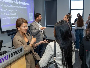 Executives networking with students