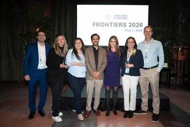 A group stands in front of a sign reading "Frontiers 2026" with the Endless Frontier Labs logo