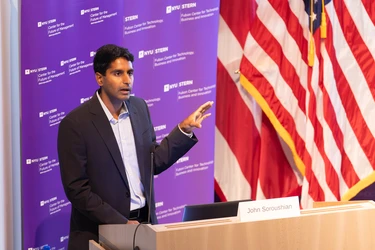 chandar speaking at podium