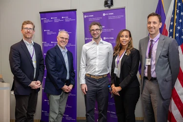 moderator and panelists posing for the camera