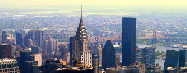 Photo of NYC skyline featuring the Brooklyn Bridge.